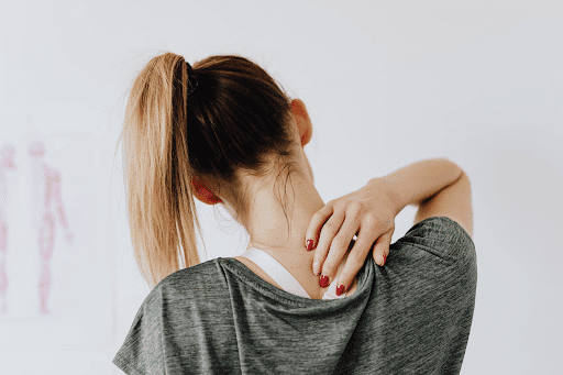 Woman reaching for her back CBD for chronic pain